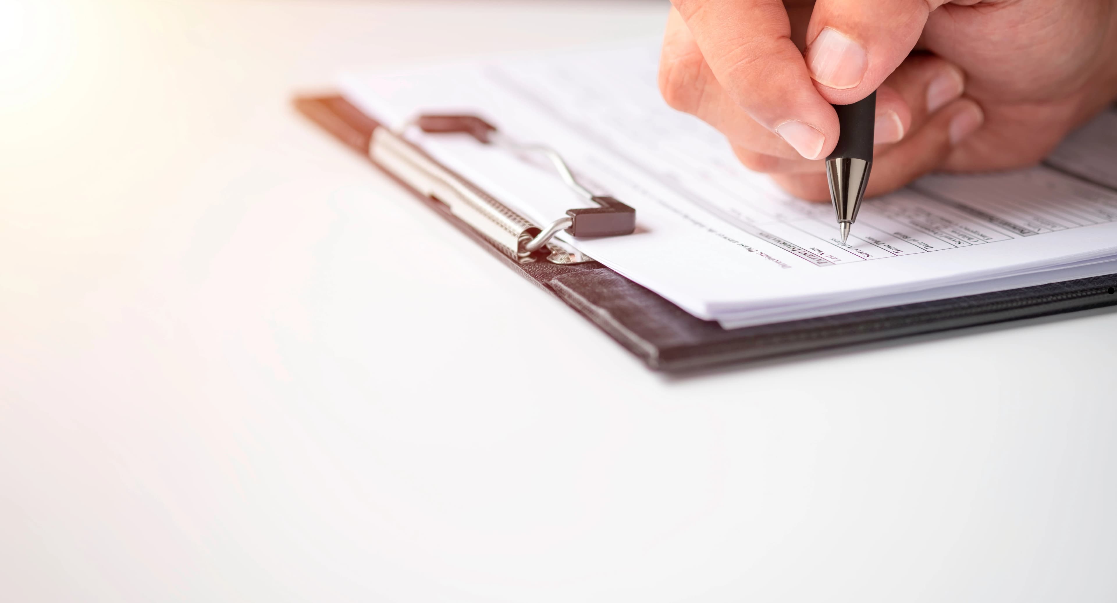 A person filling out a form or packet