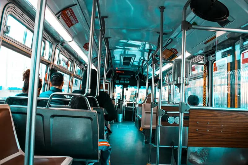 An image inside a bus with passengers sitting.