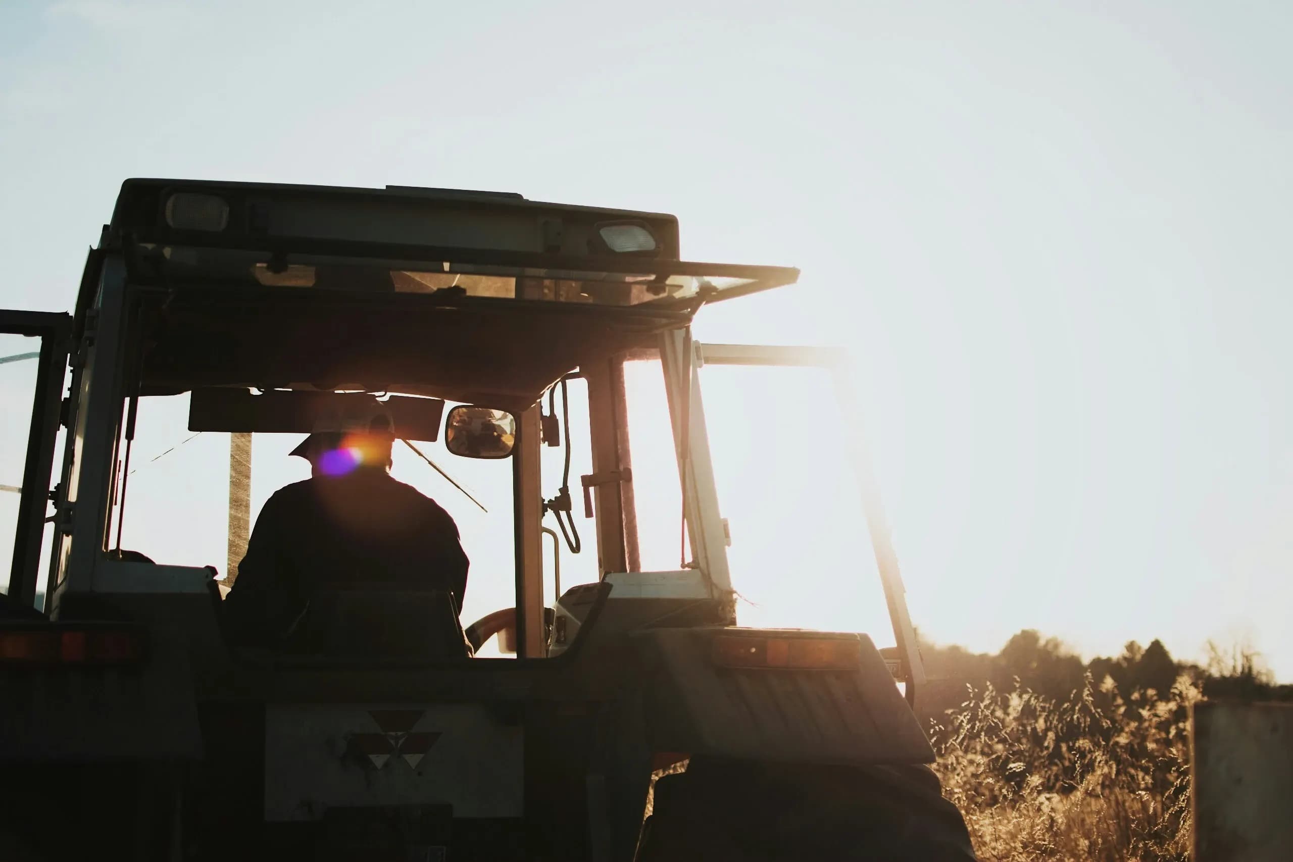 Farm worker using a tractor.